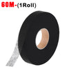 Roll of black double-sided iron-on fabric adhesive tape with a visible core.