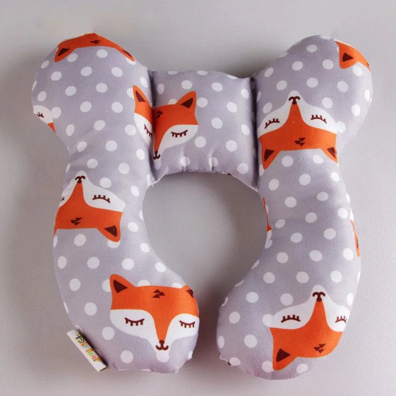A gray fabric pillow shaped like a fox head designed as a baby head and neck support for car seats.