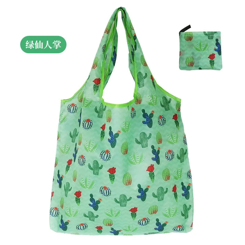 A light green reusable nylon shopping tote bag featuring a pattern of cacti and succulents.