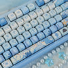 Close-up view of light blue and white Ocean Blue MOA Profile PBT keycaps for mechanical keyboards