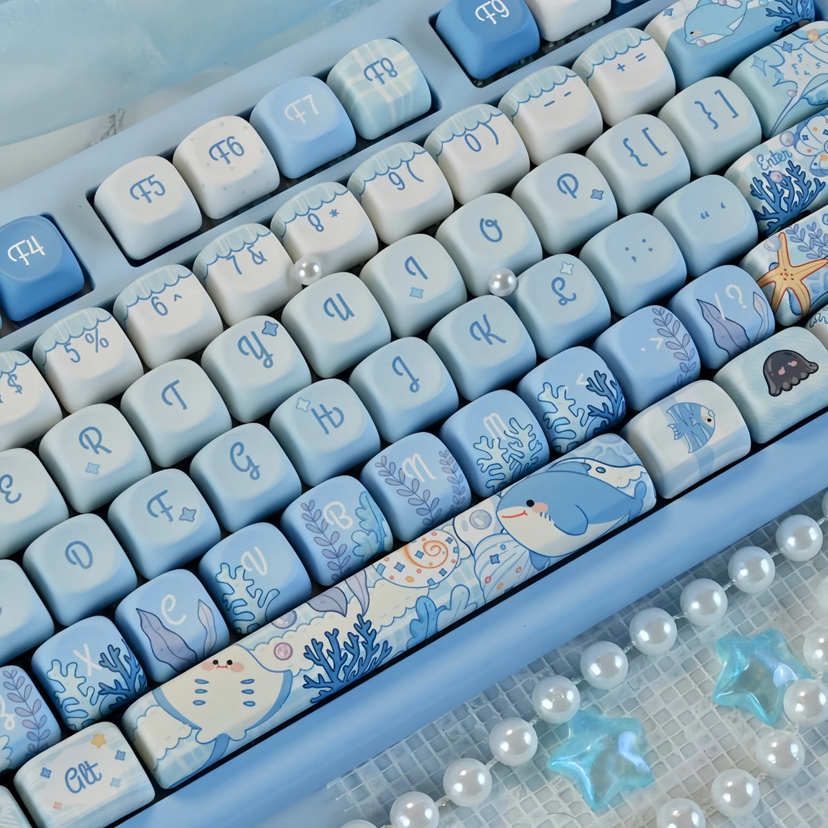 Close-up view of light blue and white Ocean Blue MOA Profile PBT keycaps for mechanical keyboards