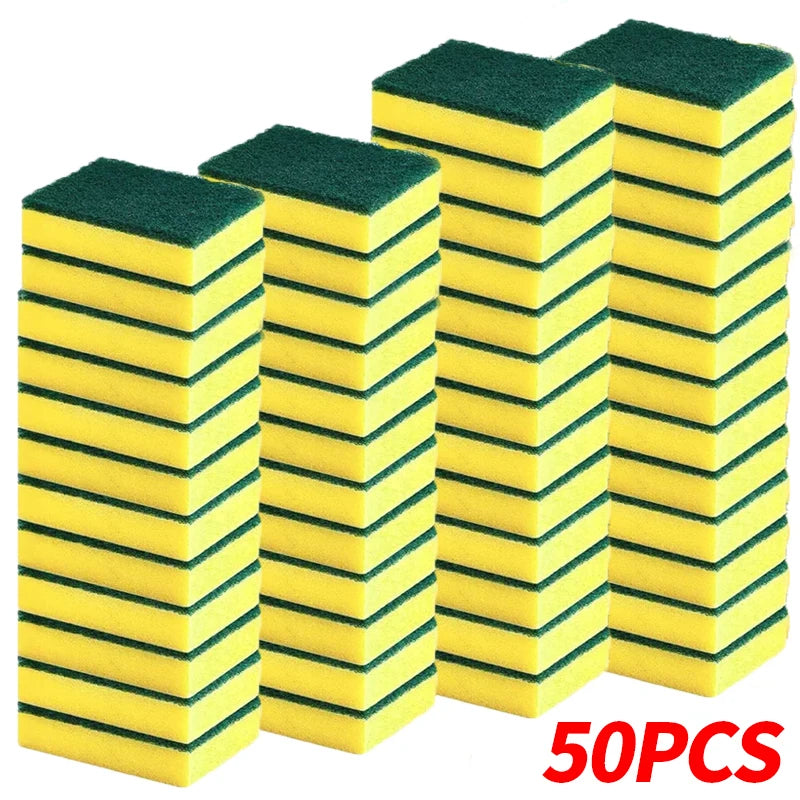 A stack of green and yellow dual-sided scrub sponges for kitchen cleaning.