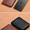 A brown leather card holder wallet and a black leather wallet placed next to an iPhone.