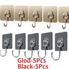 A set of five black self-adhesive rotating wall hooks for storage.