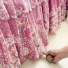 Pink floral print bed skirt fabric draped in soft folds