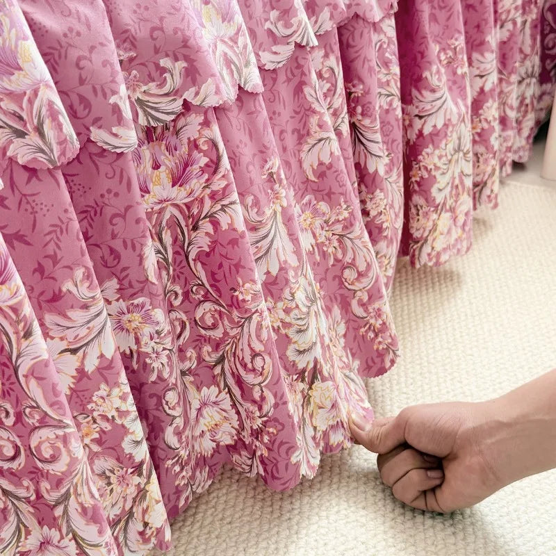 Pink floral print bed skirt fabric draped in soft folds