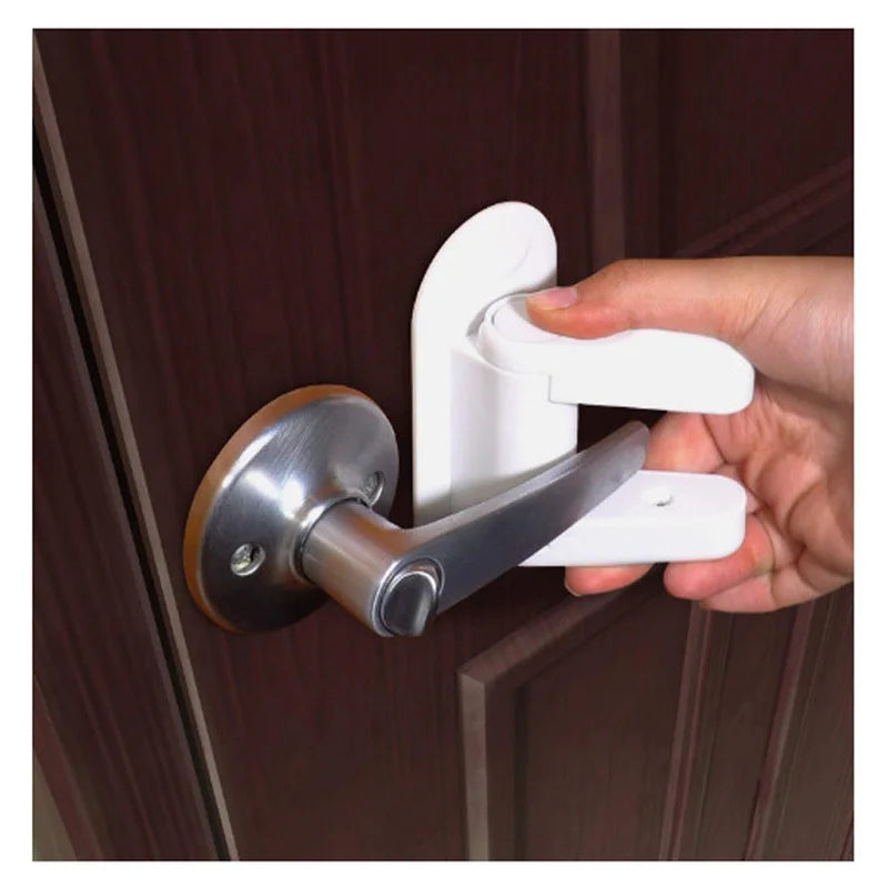 A hand is operating a white adhesive anti-open latch for a door lever lock on a wooden door.