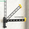 Black foldable wall-mounted clothes drying rack with adjustable arms shown mounted on a light-colored wall.