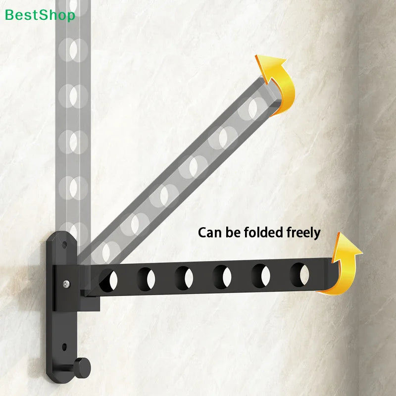 Black foldable wall-mounted clothes drying rack with adjustable arms shown mounted on a light-colored wall.