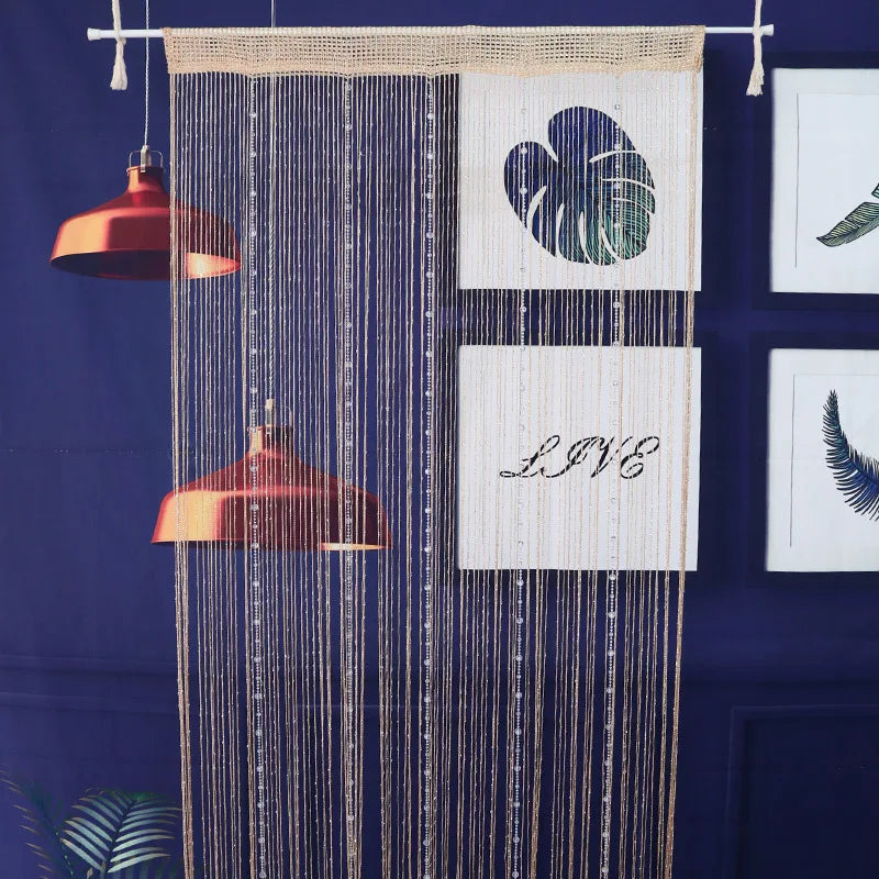 A beaded string curtain with a dark blue background featuring a heart design and the word LIVE.