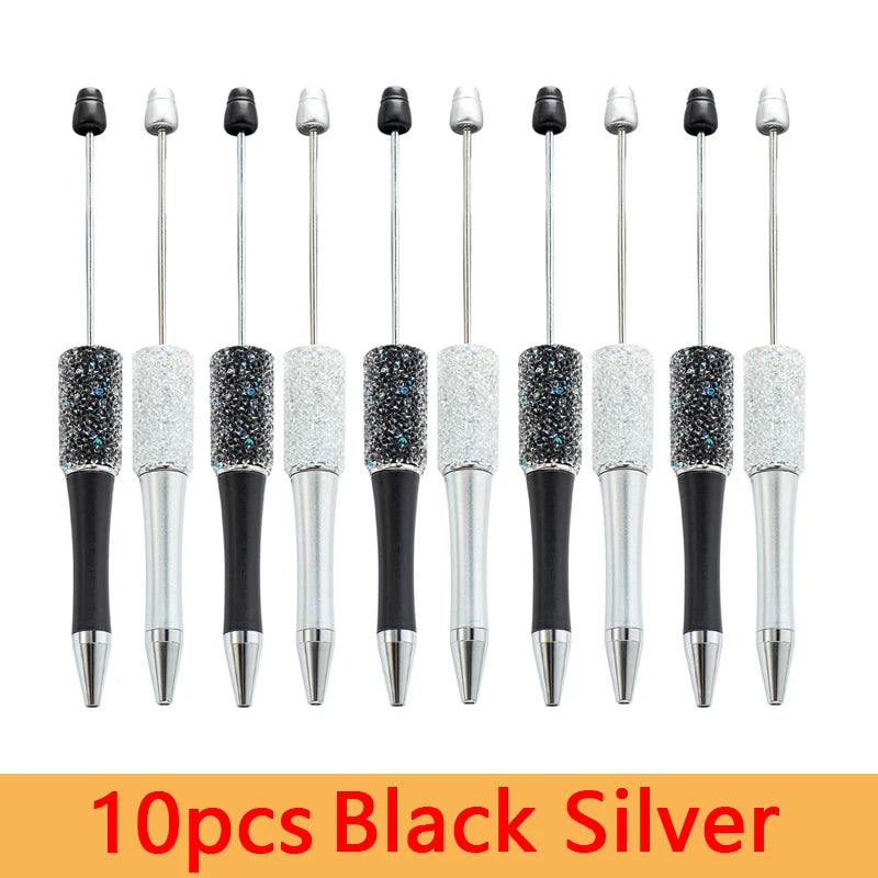 A set of 10 black and silver beaded ballpoint pens displayed in a row.