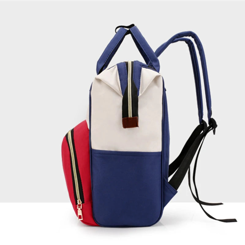A navy blue and beige insulated canvas diaper bag with a red accent, featuring a hanging hook.