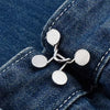 Silver metal button snaps used for adjusting the waist of denim jeans