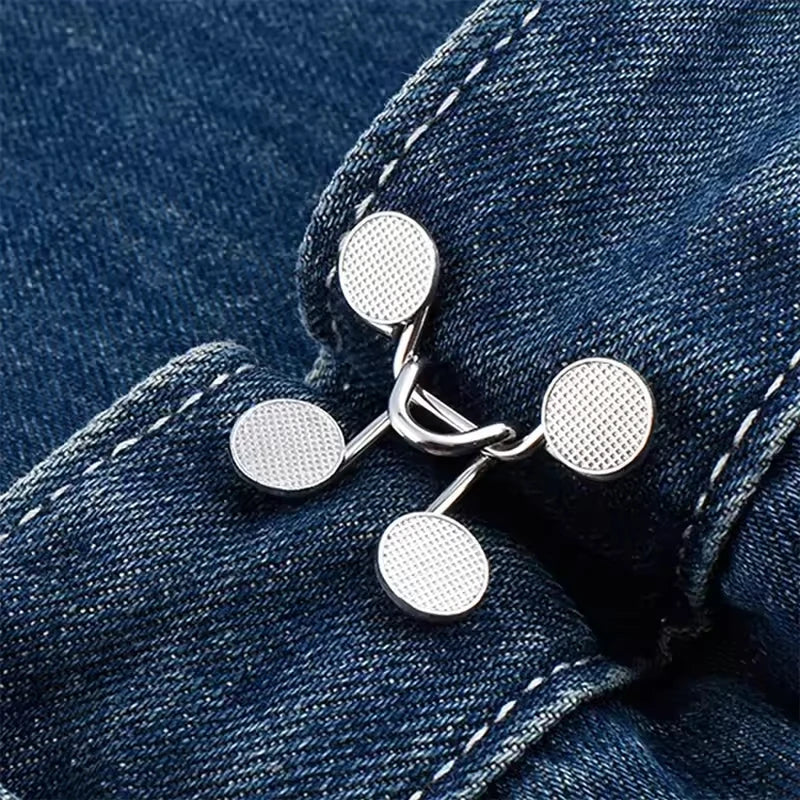 Silver metal button snaps used for adjusting the waist of denim jeans