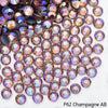 Close-up of iridescent champagne-colored rhinestones scattered on a white background.