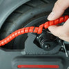 A hand is installing an orange cable protector sleeve onto a motor component of an electric scooter.