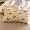 A beige duvet cover set featuring a repeating pattern of small orange and black striped dog silhouettes.