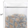 A white mesh laundry bag filled with a pile of light brown and blue fabric items.