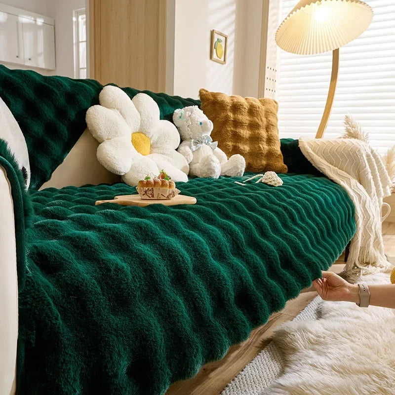 Tiefgrünes Plüschkaninchen-Sofa-Kissen mit weißen und goldenen Akzenten auf hellem Holz.