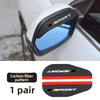 A pair of black carbon fiber rain covers designed for car side mirrors.