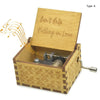 A vintage hand-cranked wooden music box plays the song Can't Help Falling in Love.