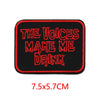 Black embroidered iron-on letter patch with red text that reads The Voices Make Me Drink