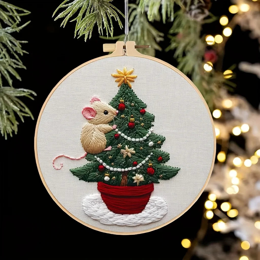 A handcrafted Christmas embroidery kit featuring a small mouse nestled in a green pine tree potted in a red ceramic pot.