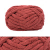 A ball of chunky chenille yarn in a dusty rose or terracotta color.