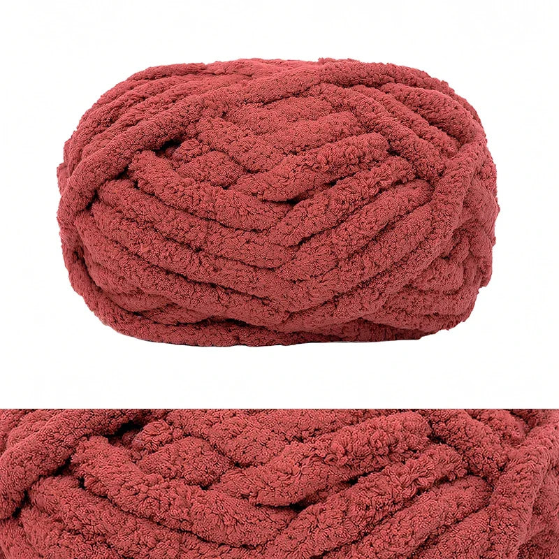 A ball of chunky chenille yarn in a dusty rose or terracotta color.