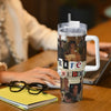 A clear insulated stainless steel tumbler with a straw lid featuring a collage of faces and text on a wooden table.