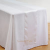 Elegant satin table runner in white fabric draped over a table.