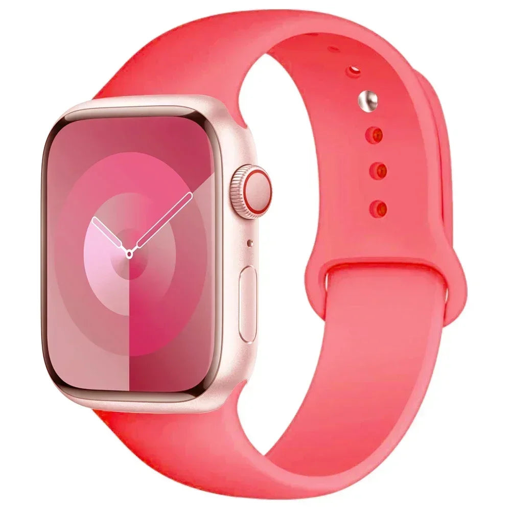 A pink silicone sport band for an Apple Watch shown on a white background.