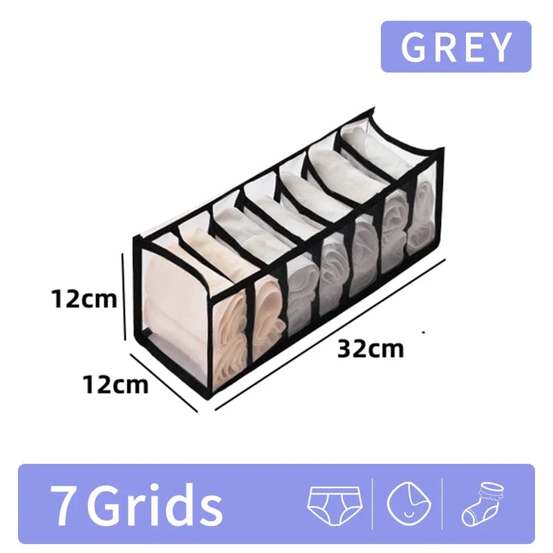 A grey foldable closet organizer box with seven grids for storing underwear, socks, and accessories.