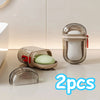 Two clear glass portable travel soap boxes with drainage lids and white soap inside