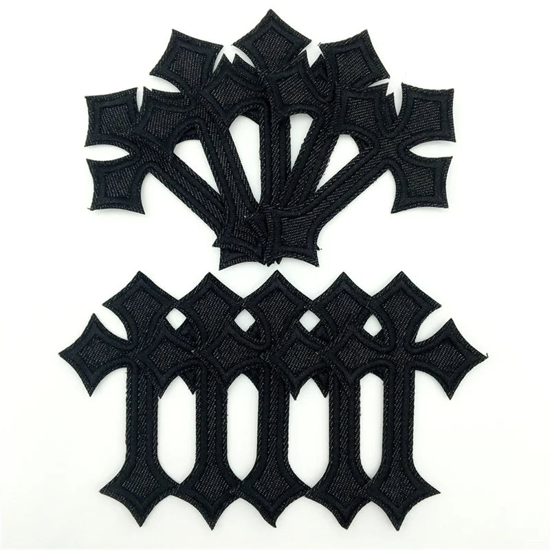 A set of ten black embroidered cross iron-on patches with intricate detailing.