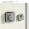 A gray retractable clothesline with a round knob is installed on a light-colored wall.
