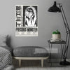 A poster featuring a black and white illustration of a character titled Precious Monster displayed on a gray wall.