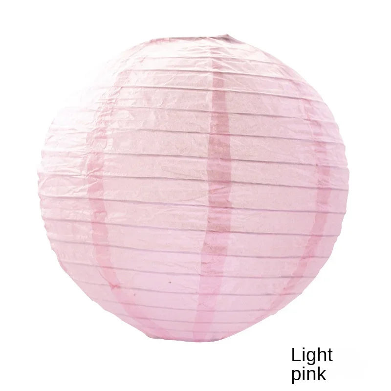 A round pink paper lantern with vertical folds.