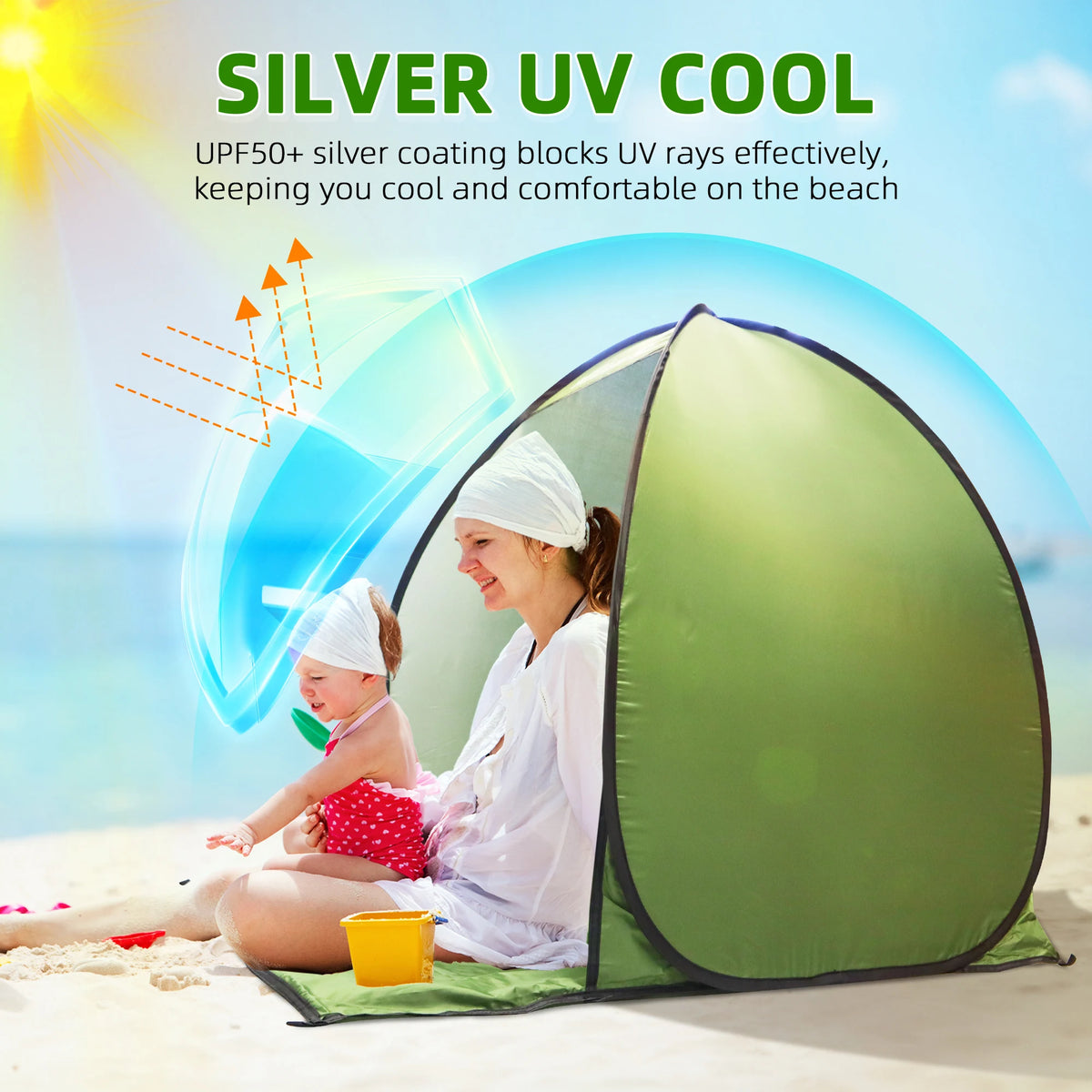 A woman is using a silver UV cool instant pop-up beach tent to protect a baby on the sand.
