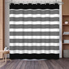 Black and white geometric stripe pattern shower curtain hanging on a rod