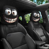 A set of two black smiley face car headrest cushion covers installed in a vehicle interior.