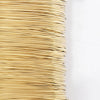 A tightly wound spool of thin, golden copper-clad steel sculpting wire.