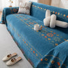 A deep blue bohemian jacquard sofa cover featuring geometric patterns and decorative stitching.