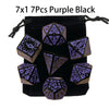 A set of seven polyhedral dice in purple and black colors packaged in a black pouch.