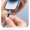A hand is connecting a magnetic fast charging cable to an iPhone, demonstrating easy device charging.