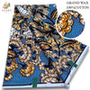 A bolt of brown and orange African wax print fabric featuring a floral pattern on blue background