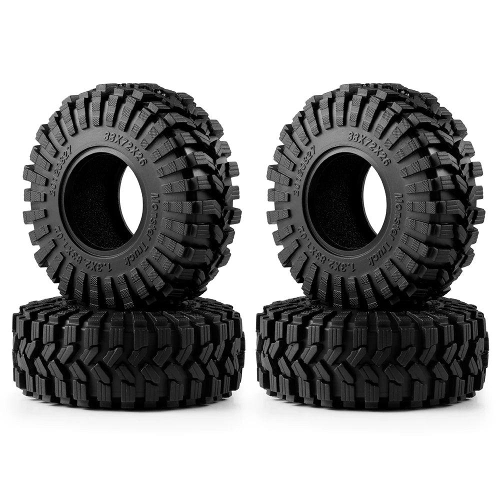 A pair of black mud terrain rubber tires for RC crawlers, shown in a stacked arrangement.