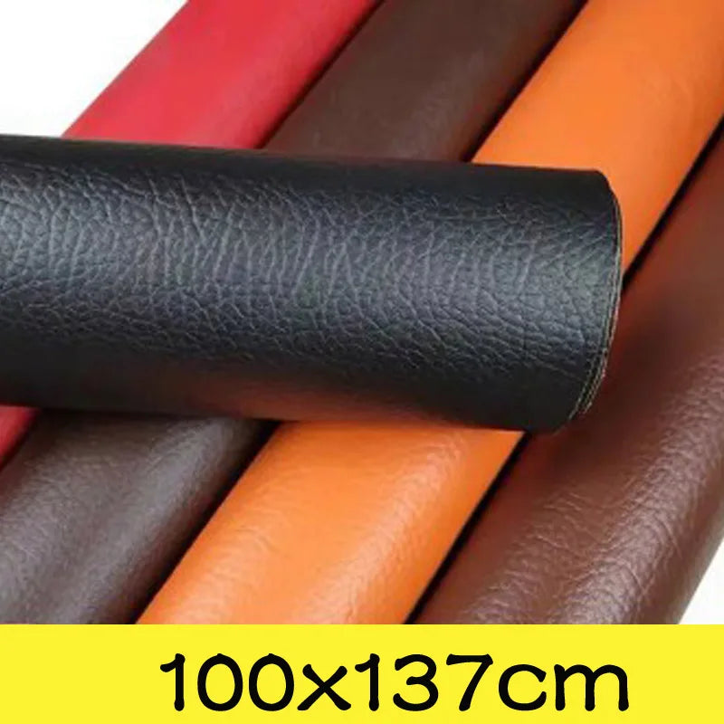 A roll of black PU leather patch next to several rolls of brown, red, and orange leather.