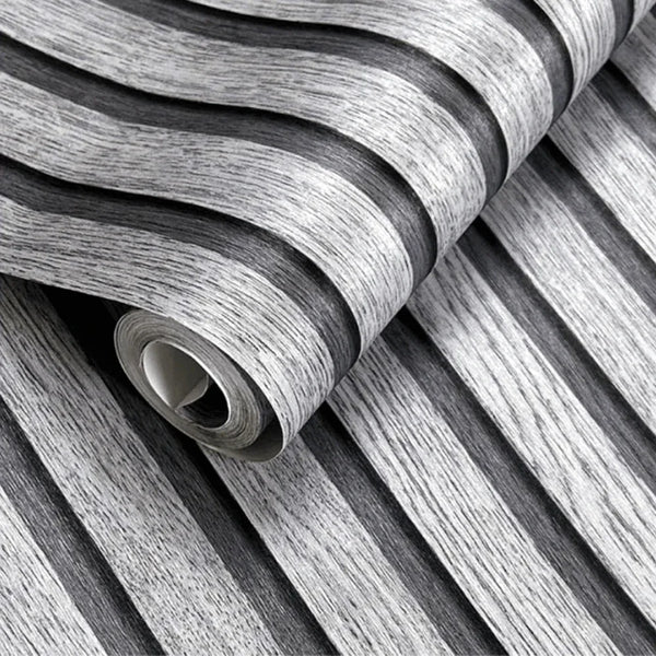 Roll of wood grain self-adhesive wallpaper showing vertical stripes in gray and white.