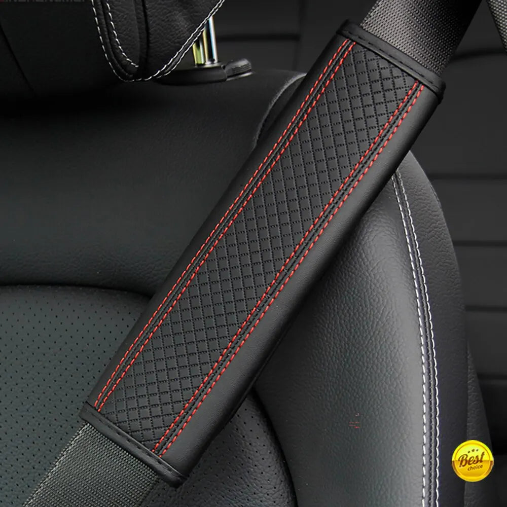 Close-up of a black PU leather embossed seat belt shoulder cushion with red stitching on a vehicle seat.